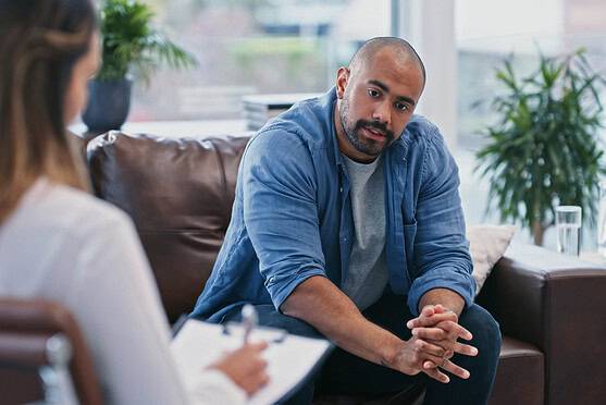 Professional therapist providing mental health support and stress relief strategies during a counseling session for an expat going through burnout recovery