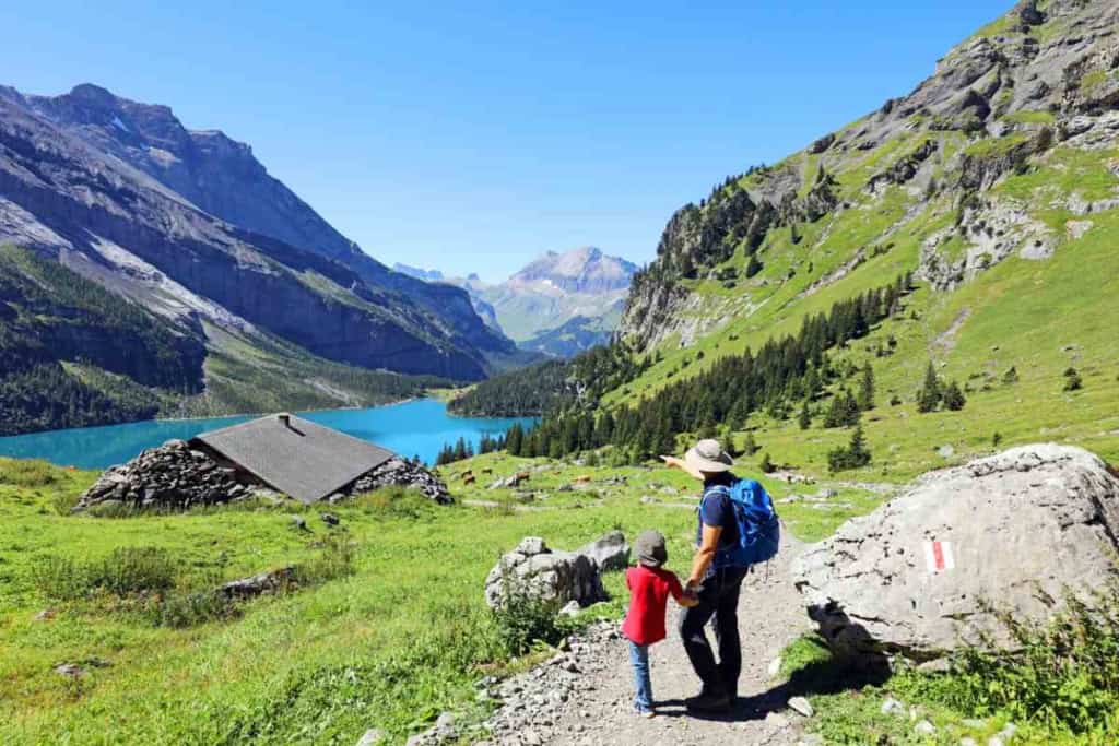 a father and son hiking in the Swiss Alps in Switzerland, one of the best countries to live in