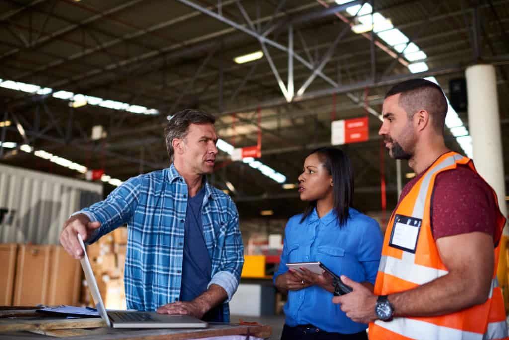 logistics professionals at a warehouse, showing one of the most popular overseas jobs for expats