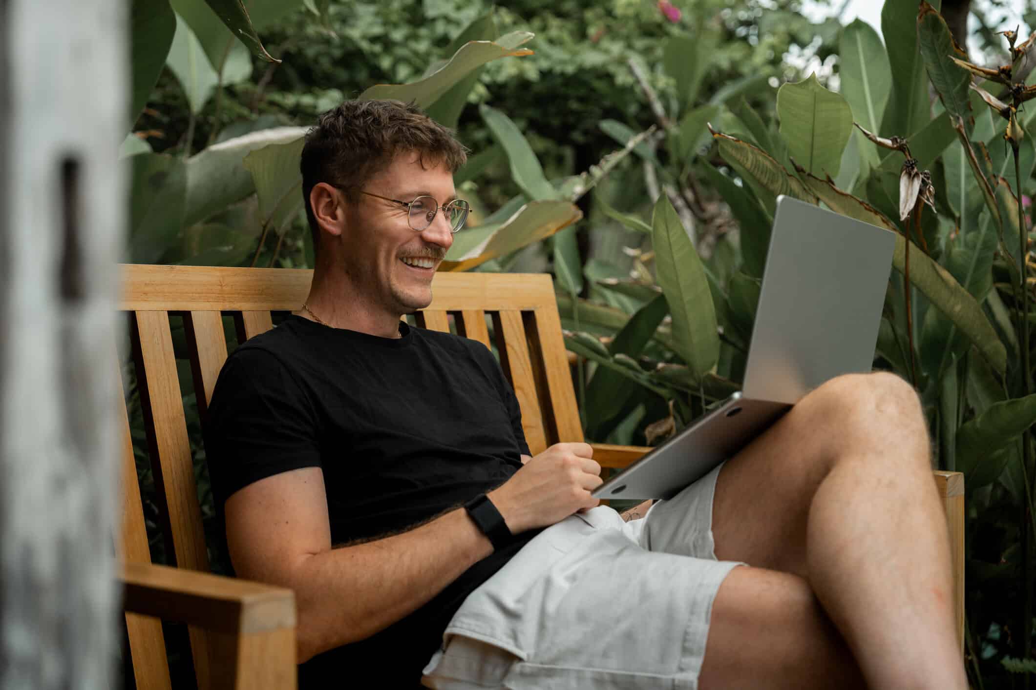 man remote working on his laptop in a tropical garden Lombok, Indonesia 