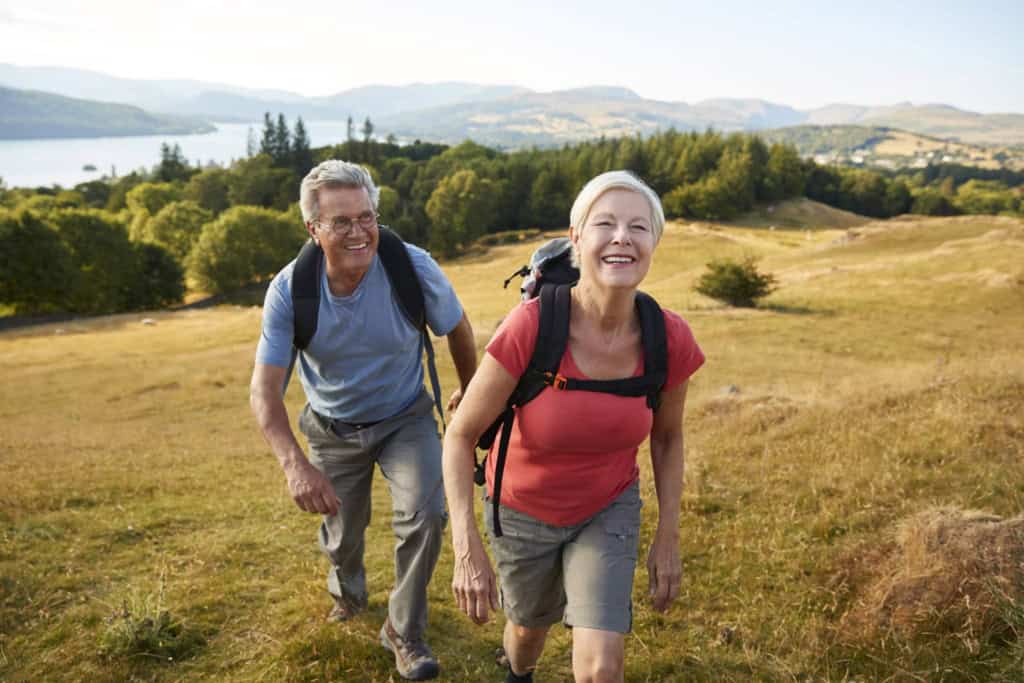 a senior couple hiking in the hills, learning valuable travel lessons from their international trip