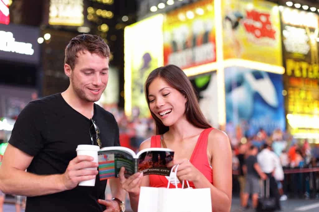 a couple reading a travel guide, while learning valuable travel lessons for life