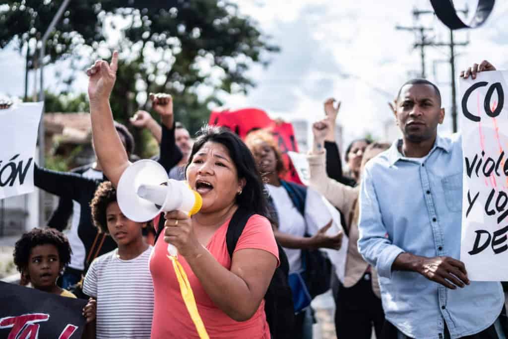 Mature woman talking in a megaphone during a protest in the street in Spain