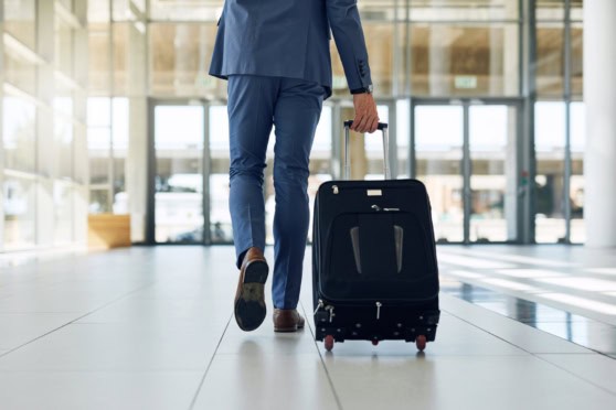 business man walking with a suitcase, indicating the end of a global assignment due to expatriate failure