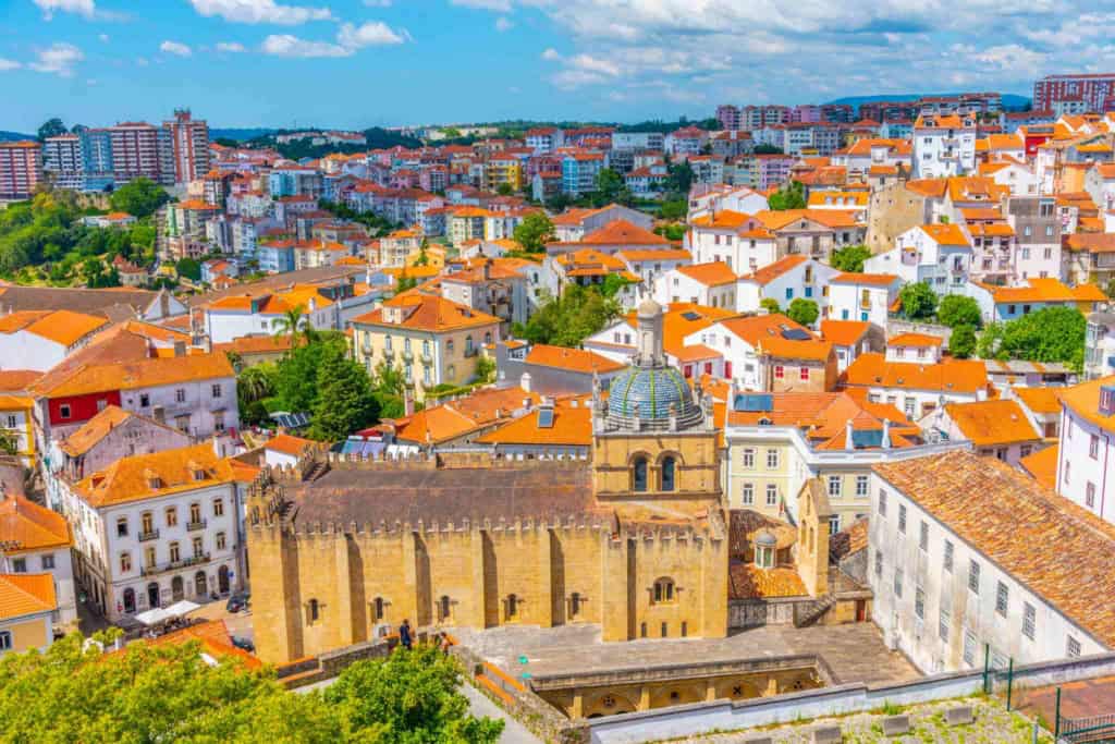 Scenic view of a Portuguese city with historic buildings and orange-tiled roofs, ideal for retirees considering Portugal as a top retirement destination.