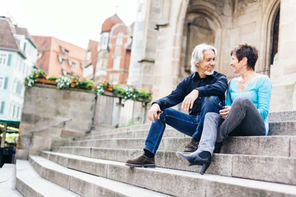 a couple sitting on the steps of 