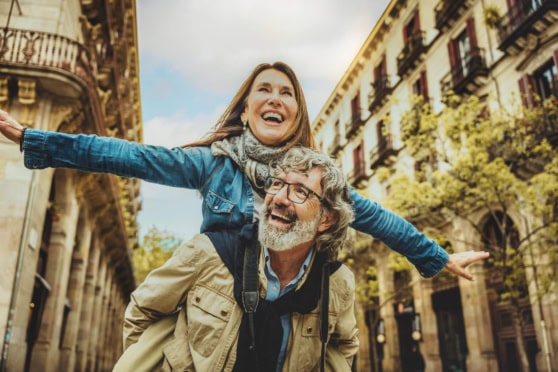 An elderly couple who decided to retire in France, enjoying a joyful moment.