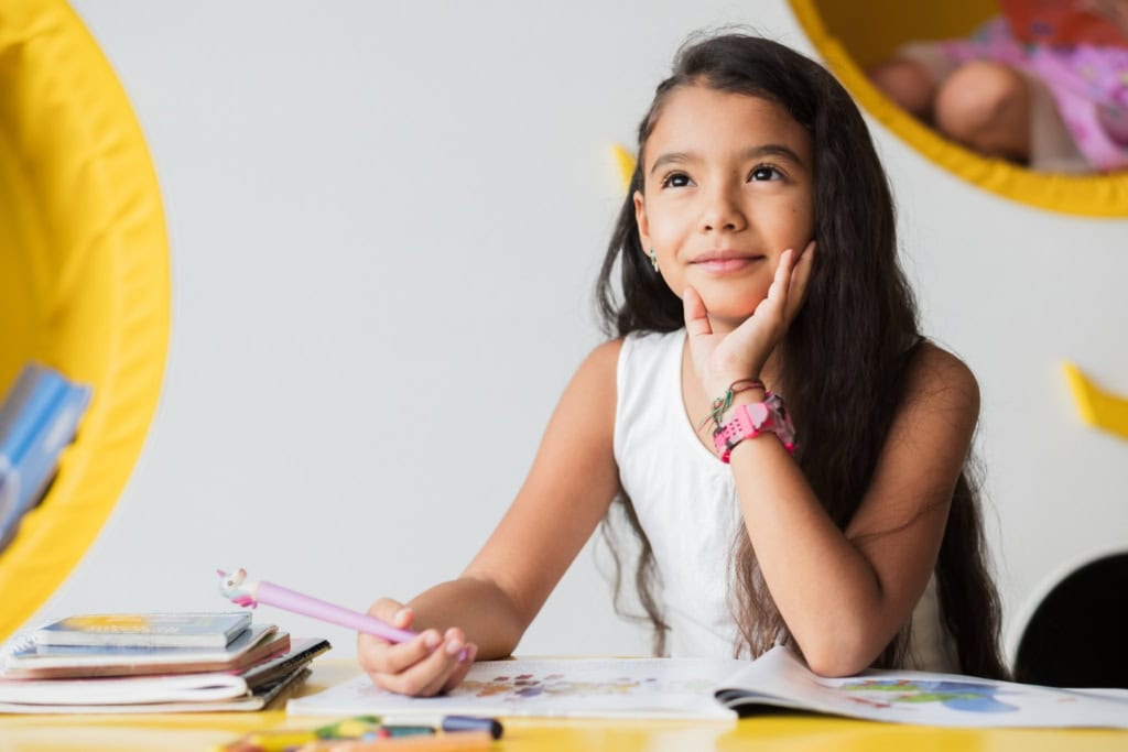 a young school girl studying at her desk at one of the best international schools in the world