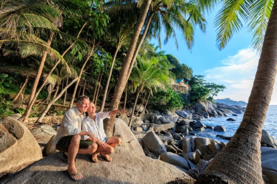 happy retired couple on the beach in Koi Sumai, one of the best places to retire in Thailand