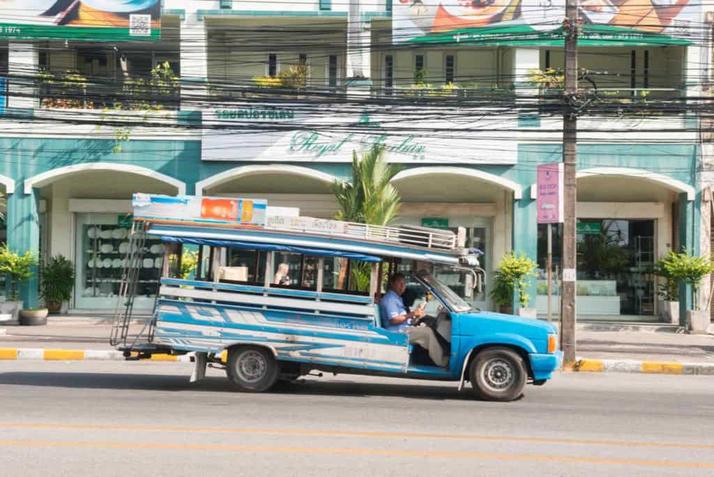 A traditional tuk-tuk vehicle on a busy street in Thailand, showcasing local transportation options for retirees exploring the country.