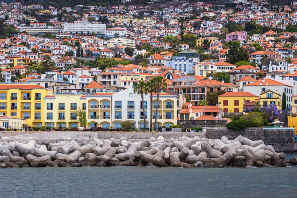 An overview of a colorful seaside neighborhood in Portugal with vibrant buildings and scenic ocean views.