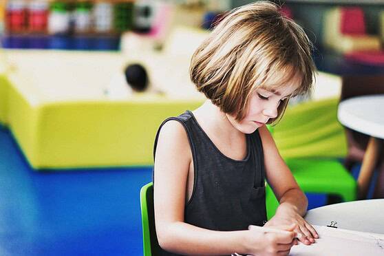 Young girl studying at an international school in Spain, highlighting global education options for children.