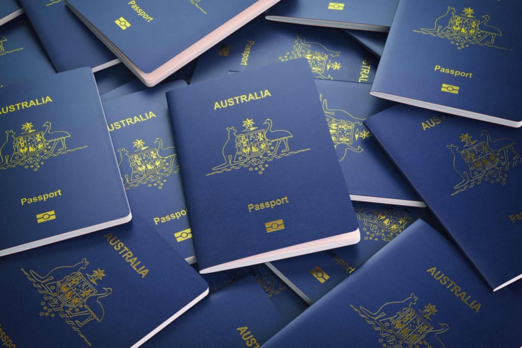 Multiple Australian passports stacked, symbolizing citizenship and international travel opportunities for Australian citizens.