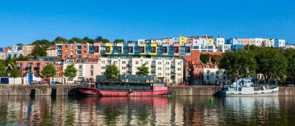Vibrant, colorful houses lining the waterfront in Bristol, one of the best places to live in the UK