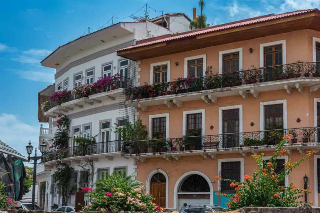Panama City residential building with colorful balconies and lush greenery, illustrating the safe and vibrant environment for foreigners living in Panama.