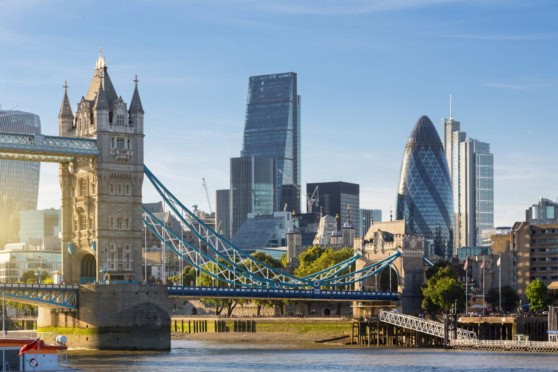 London skyline featuring Tower Bridge and iconic modern buildings in the financial district.