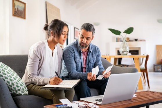 US expats reviewing FATCA compliance documents with financial advisor at home.