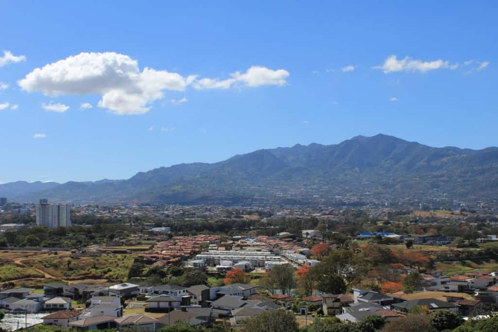 Panoramic view of Costa Rica's mountains and cityscape, highlighting the scenic landscape and urban areas suitable for expatriates and retirees.