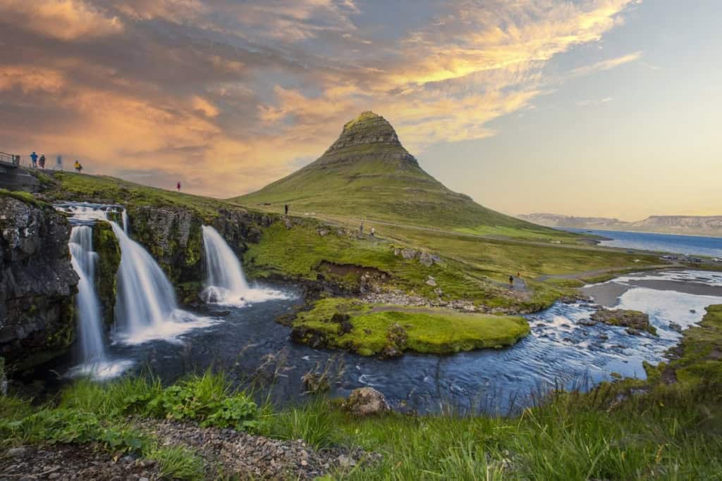 Kirkjufell mountain with waterfalls in Iceland, a popular destination for travelers seeking scenic views and outdoor adventures.