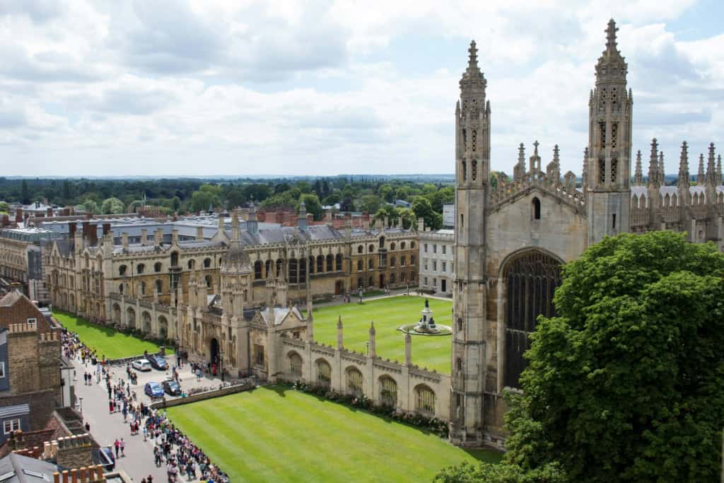 View of the historic University of Cambridge with its iconic Gothic architecture and lush green courtyards, situated in the heart of the UK.