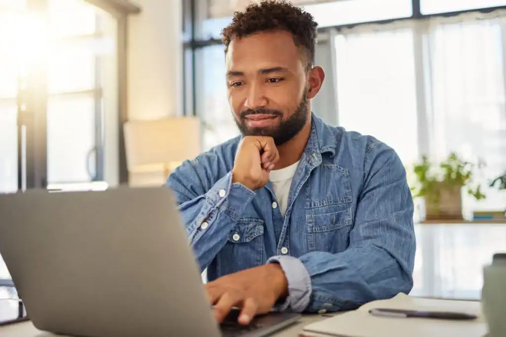 a man on his laptop researching visas for moving to Brazil