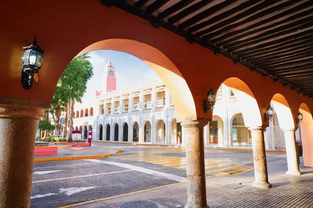 Historic town hall building in Mexico featuring colonial architecture, a prominent clock tower, and arched walkways, representing the charming and historic atmosphere of popular retirement destination.