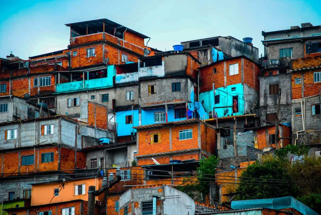 Colorful hillside favela in Brazil with densely packed houses and vibrant colors, showcasing urban living in a developing country.