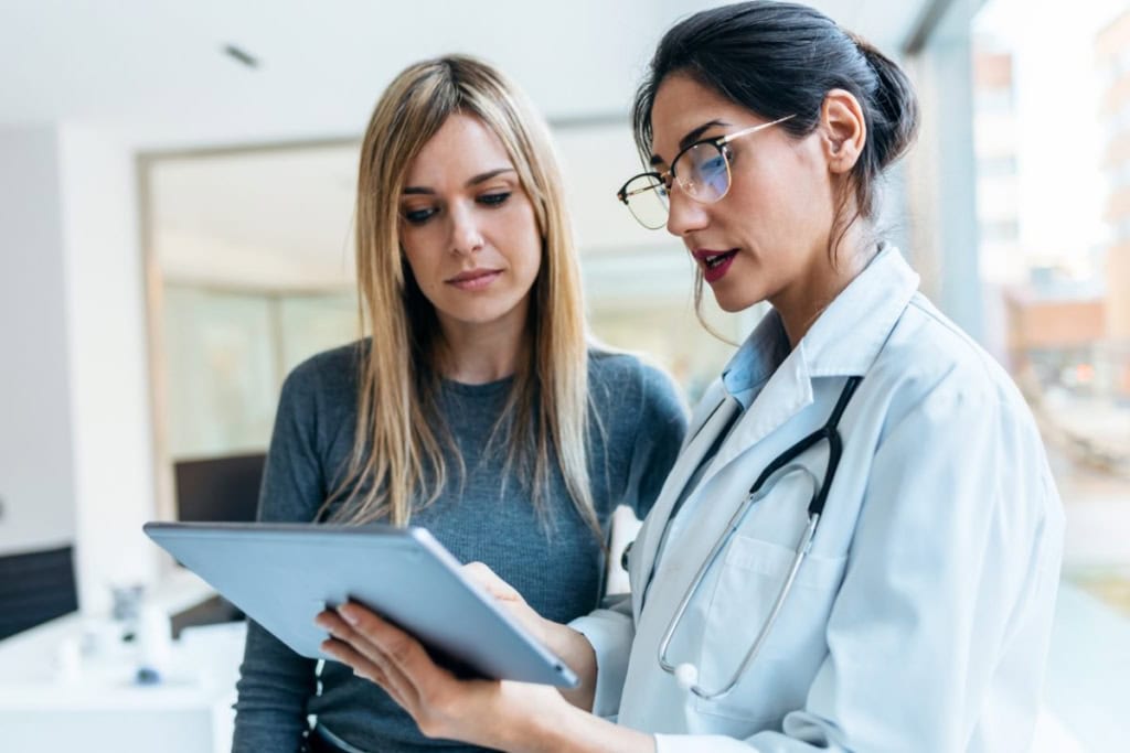 Healthcare professional consulting with a patient, discussing medical options in a modern clinic setting.
