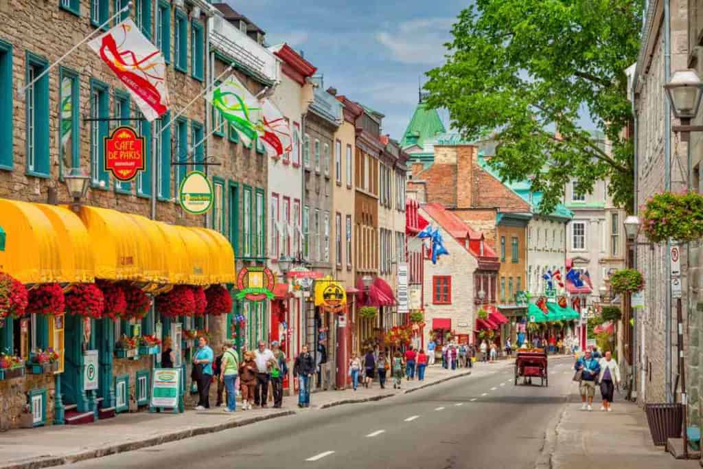 Brightly colored buildings and lively street scene in a Canadian city.