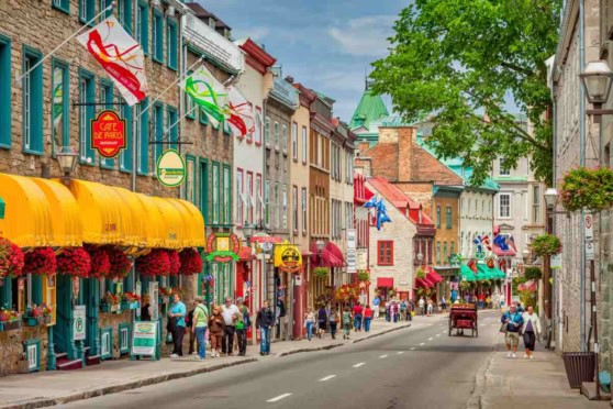 Brightly colored buildings and lively street scene in a Canadian city.