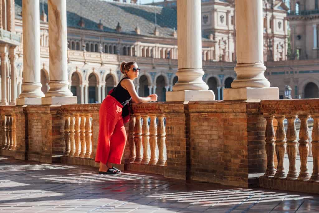 An image of a woman enjoying the historic architecture in Spain, highlighting the importance of international health insurance for expatriates living abroad.