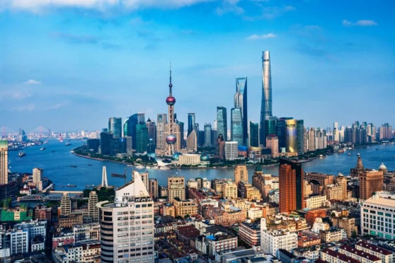 Shanghai skyline with iconic skyscrapers and the Huangpu River, showcasing the vibrant city life and modern architecture in China’s most populous city.