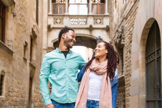 Expat couple enjoying their time in a historic Spanish city, highlighting the importance of international health insurance for living abroad.