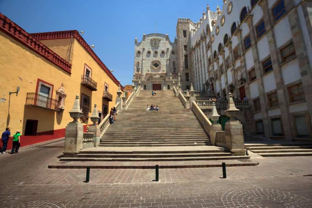Historic staircase leading to a cathedral in Mexico City, showcasing vibrant architecture and cultural heritage.