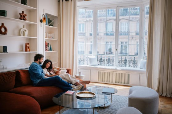 a couple relaxing in an apartment in Paris, which has the highest cost of living in France