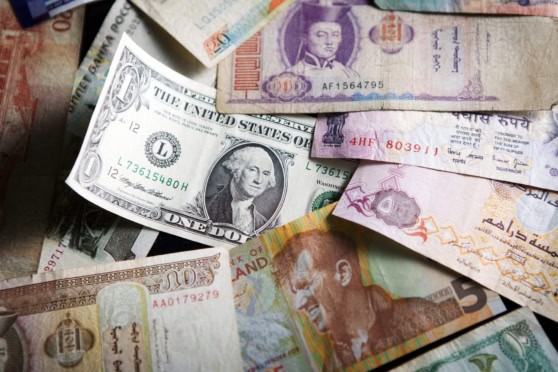 A diverse collection of international banknotes, including US dollars, Indian rupees, and other currencies, symbolizing global financial transactions and international banking.