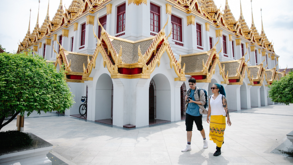 A couple exploring a temple in Bangkok, Thailand, one of the safest places to live in the world