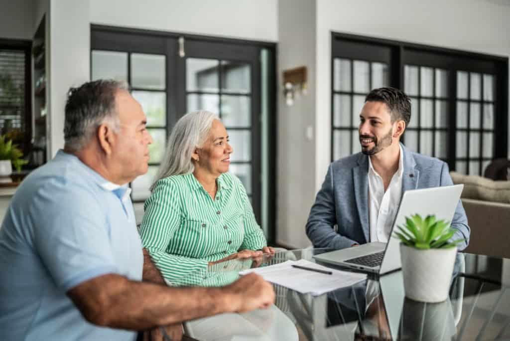 a couple with a tax consultant; an important part of retirement planning for expats moving abroad