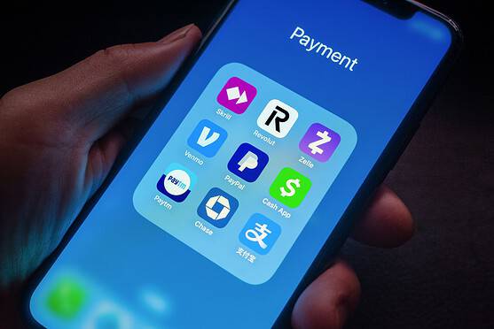 Smartphone screen displaying various apps from money transfer companies