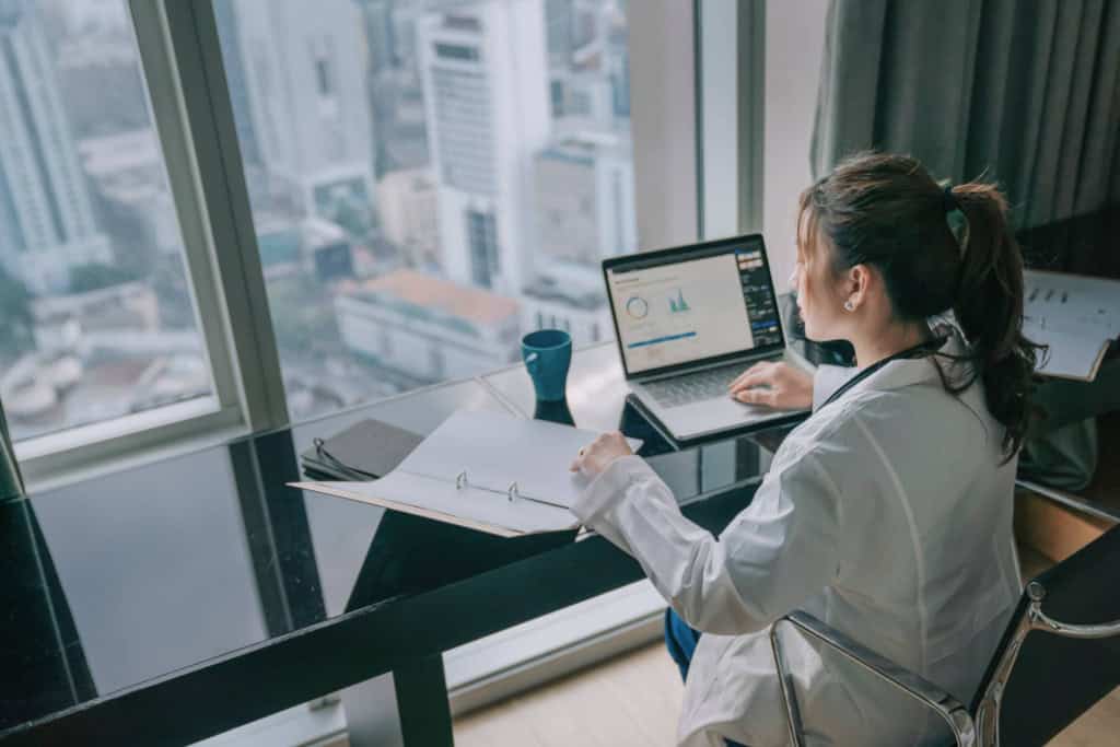 a Healthcare Customer Support Manager working on a laptop showing the demand for remote jobs in the healthcare sector
