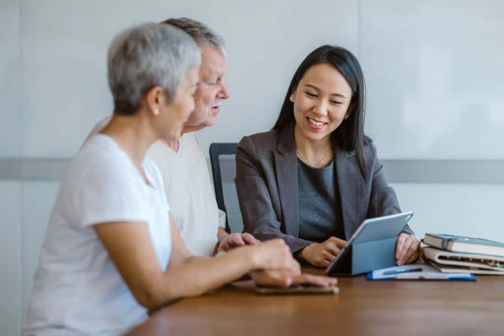 Retired couple discussing estate planning with a financial adviser in the USA