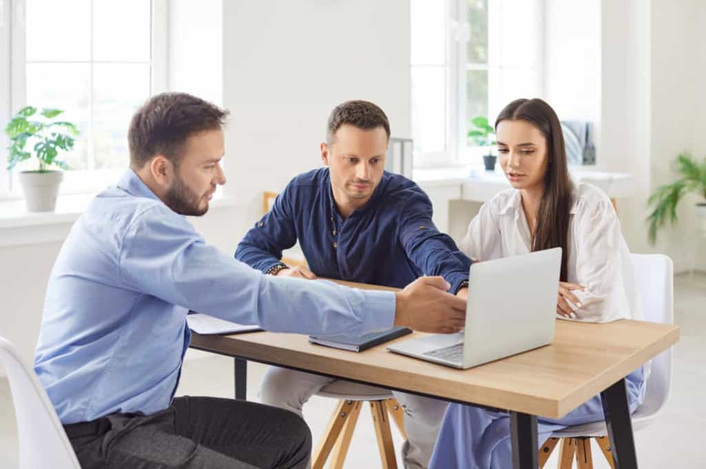 an international insurance broker reviewing coverage options with clients during a consultation