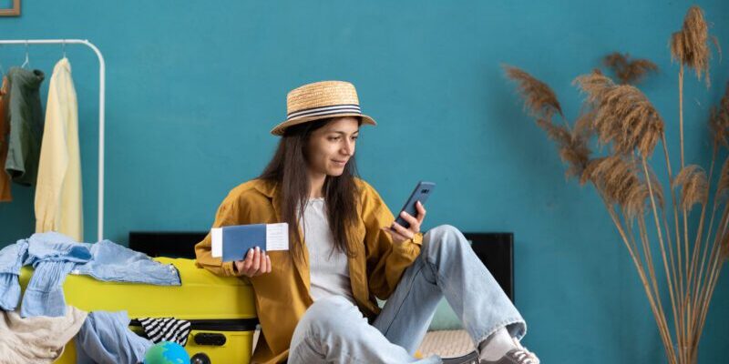 a woman re-booking her flight using the reimbursement she received from her trip cancellation insurance plan, after weighing up whether to buy travel insurance vs health insurance for her trip