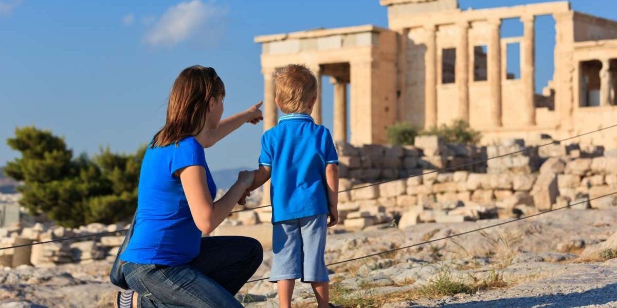 family-athens-greece a mother and son looking at the Acropolis in Athens, Greece, one of the best family vacation ideas for 2025