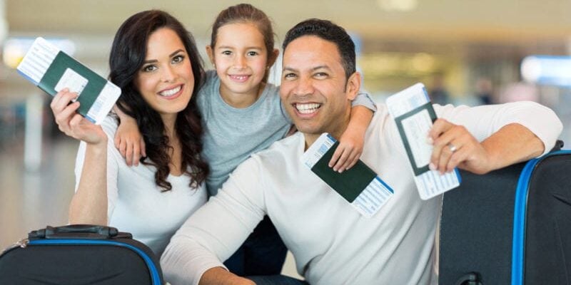 family holding their passports to travel