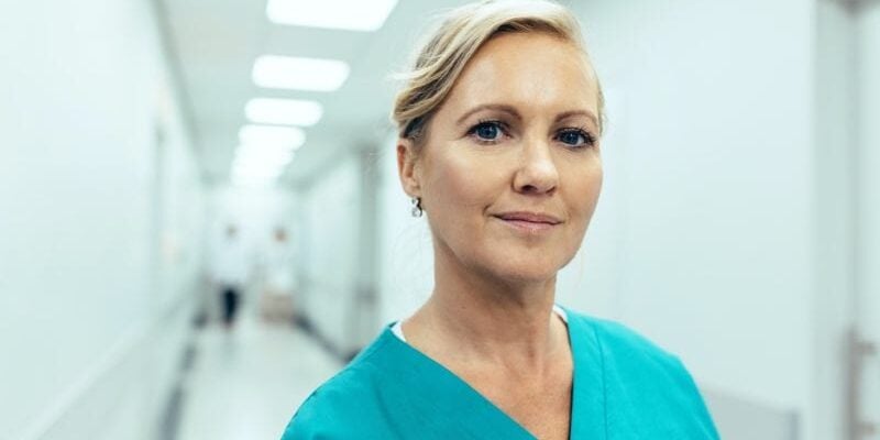 Female healthcare worker standing in hospital corridor female healthcare worker