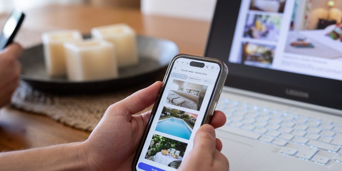 hotel-booking-app a person viewing hotel listings on an app on their smartphone, one of the prime targets of travel scams