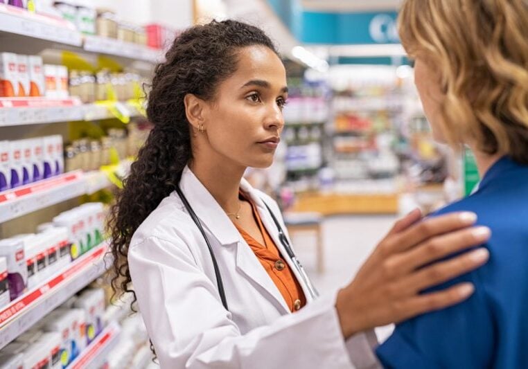 Pharmacist and customer in pharmacy
