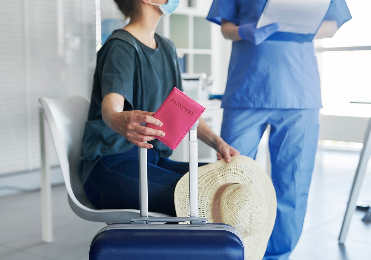 Woman with luggage and doctor