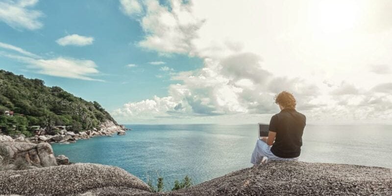 digital nomad working by ocean